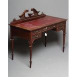 A LATE VICTORIAN MAHOGANY WRITING DESK, the moulded edged top inset with tooled red leather, and