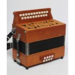 A SANDPIPER MELODEON D/G, with fret carved decoration, faux mother of pearl keys, leather straps and