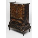 A CHINESE BLACK LACQUERED TABLE CABINET, c.1900, of oblong form with gilt metal mounts,and set