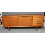 A NILS JONSSON FOR TROEDS TEAK TRENTO SIDEBOARD, with two sliding doors enclosing shelving flanked