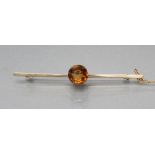 A BROOCH, the propeller bar stamped 15ct, centred by a claw set circular facet cut citrine (Est.