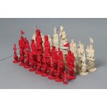 A COMPOSITE CHINESE IVORY PUZZLE BALL CHESS SET, natural and stained red, red King 5 3/4" high