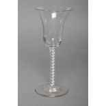 A WINE GLASS, mid 18th century, the bell bowl on double helix opaque spiral with pale blue edging,