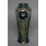 A MOORCROFT POTTERY FLORIAN WARE VASE, early 20th century, of slender inverted baluster form,