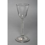 A WINE GLASS, mid 18th century, the round funnel bowl on a coarse incised stem and domed foot, 6 1/
