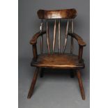 A PRIMITIVE STICK BACK WINDSOR ARMCHAIR, 19th century or later, in ash and fruitwood, curved rounded