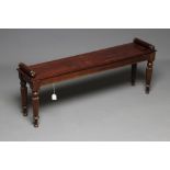 A MAHOGANY HALL BENCH, 19th century, the moulded edge oblong seat with applied gadrooned bolsters to