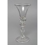 A TALL WINE GLASS, c.1740, the bell bowl on knopped and tear stem and folded foot, 7" high (