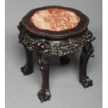A CHINESE PADOUK WOOD JARDINIERE STAND, c.1900, the beaded edged lobed circular top inset with rouge