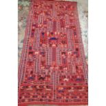 A KILIM, modern, the brick ground with figures, animals and plants in navy blue, pale green,