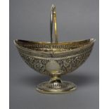 A VICTORIAN SILVER GILT SUGAR BASKET, maker Henry Holland, London 1879, of oval form with reeded