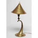 AN ARTS AND CRAFTS STYLE BRASS TABLE LAMP, early 20th century, the hammered conical shade with