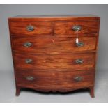 A REGENCY MAHOGANY BOWED CHEST of two short and three long cockbeaded drawers, later brass oval drop