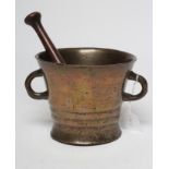 A BRONZE MORTAR, 18th century, of tapering form with moulded banding and plain loop handles, 6 1/