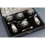 A SILVER COMPOSITE SIX PIECE CRUET, maker Adie Bros., Birmingham 1935, 1938 and 1942 and Chester