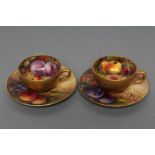 A PAIR OF ROYAL WORCESTER CHINA SMALL CABINET CUPS AND SAUCERS, 1919/20, painted in polychrome