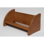 A ROBERT THOMPSON ADZED OAK BOOK TROUGH, the quadrant shaped ends with carved mouse trademark in