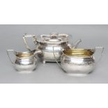 A LATE GEORGE III SILVER MATCHED THREE PIECE TEA SERVICE, maker Emes & Barnard, London 1808 (teapot)