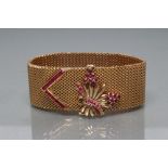 A COCKTAIL BRACELET, the mesh woven 1" wide strap with open oblong clasp panel surmounted by a