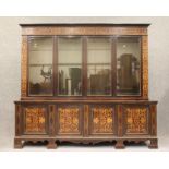 A DUTCH DARK STAINED MAHOGANY AND FOLIATE MARQUETRY BOOKCASE, c.1900, with bead and reel and ovolu