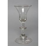 A WINE GLASS, c.1725, the bell bowl on triple annulated balustroid ring stem, on domed folded