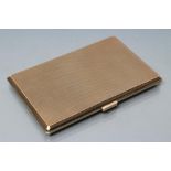 A 9CT GOLD CIGARETTE CASE, London 1967, of oblong form with engine turning, 5" x 3 1/4", 176.6g