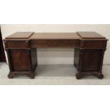 A REGENCY MAHOGANY PEDESTAL SIDEBOARD, of inverted breakfront form with stepped gadroon edged top,