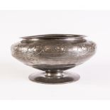 A LARGE TUDRIC PEWTER BOWL, the everted rim over a band of sinuous trailing leaves and stems in