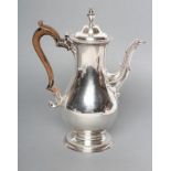A GEORGE III SILVER COFFEE POT, maker C. Wright, London 1775, of baluster form, engraved with two