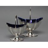 A GEORGE III SILVER SUGAR BASKET AND MATCHING CREAM BASKET, maker possibly Charles Chesterman II,