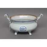 A CHINESE PORCELAIN TUREEN of squat oval form with two scroll lug handles, raised upon four out