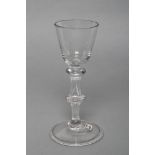 A WINE GLASS, c.1730, the round funnel bowl on a triple knopped balustroid stem and conical folded