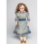 A Kestner bisque shoulder head doll, with brown glass fixed eyes, closed mouth, light brown wig,