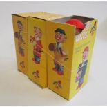 Three Eisenmann clockwork clowns in plastic and tin boxes, AF, G (Est. plus 21% premium inc. VAT)