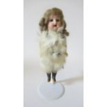 A Theodore Recknagel bisque socket head Eskimo doll, with blue glass fixed eyes, open mouth and