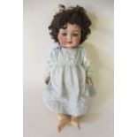 A Heubach Koppelsdorf bisque socket head flirty doll, with blue glass flirting eyes, metal