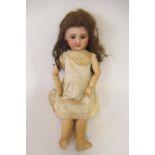 An SFBJ bisque socket head doll, with brown glass sleeping eyes, open mouth and teeth, wood and