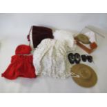 A quantity of dolls clothing, including a velvet dress, straw hat and wigs (Est. plus 21% premium