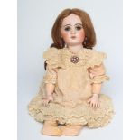 A Tete Jumeau bisque socket head doll, with blue glass sleeping eyes, open mouth, six top teeth,