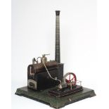 A large Carette single cylinder stationary steam engine, plated black boiler with brick base and