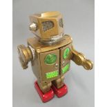 Horikawa Japan walking/shooting robot, finished in gold, minor rusting in battery box, 30mm high,