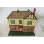 A Lines Bros type doll's house, with metal windows, porch canopy, front door, four interior doors,