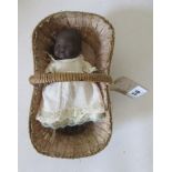 An Armand Marseille bisque black baby doll, with brown glass eyes, open mouth, two bottom teeth, and