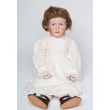 A Kammer & Reinhardt bisque socket head solemn girl, with painted features, auburn wig, wood and