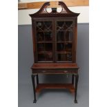 A GEORGIAN REVIVAL MAHOGANY CABINET ON STAND, late 19th century, the dentil cornice with broken fret