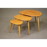 A NEST OF THREE ERCOL "PEBBLE" TABLES in light elm and beech, manufacturer's labels, largest 25 1/2"