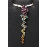 A MULTI-GEM PENDANT of elongated abstract form point set with amethysts, tourmaline, peridot and