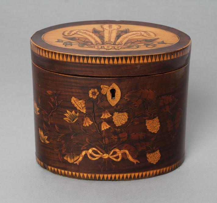 A REGENCY MAHOGANY TEA CADDY of oval form with ribbon tied marquetry flowers and berried branches,