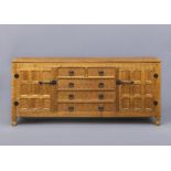 SID POLLARD OF THIRSK, an adzed oak dresser, the moulded edged top over two short and three long