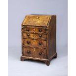 A WALNUT AND FEATHER BANDED BUREAU, early 18th century, of small proportions, originally the base of